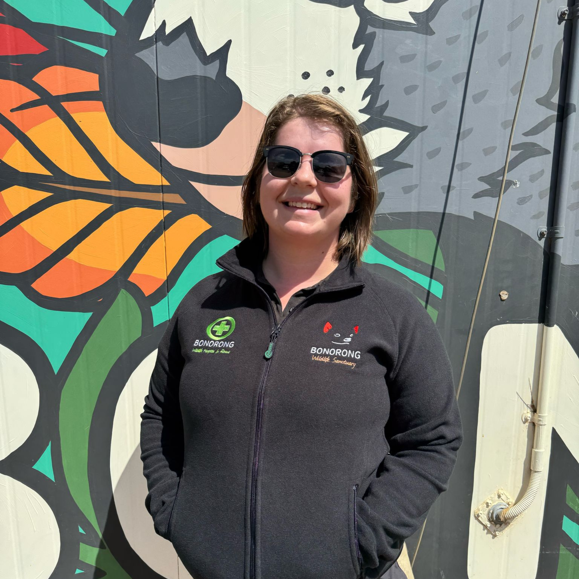 Bonorong branded fleece worn by a sanctuary staff member
